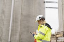Engineer in protective workwear working at construction site — Stock Photo