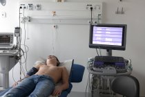 Teenage boy lying on hospital bed — Stock Photo