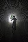 Portrait of boy on bicycle at tunnel — Stock Photo