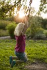 Side view of girl swinging, selective focus — Stock Photo