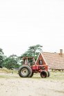 Mann fährt mit Traktor gegen Hauswand — Stockfoto