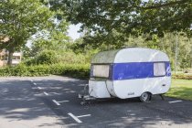 White trailer on road near trees, selective focus — Stock Photo