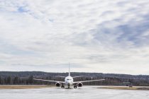 Aircraft at airport against blue sky with clouds — Stock Photo
