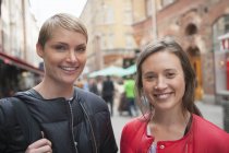 Portrait of two women in old town, focus on foreground — Stock Photo