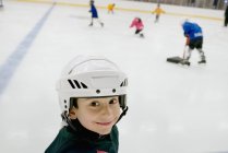 Portrait of young male hockey player on ice — Stock Photo