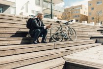 Man on staircase with bicycle in Stockholm, Sweden — Stock Photo
