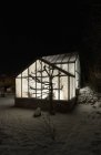Exterior of illuminated greenhouse at night, northern europe — Stock Photo