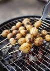 Potatoes on skewers on grill, selective focus — Stock Photo
