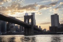 Brooklyn Bridge in New York City against sky with clouds — Stock Photo