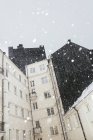 Copos de nieve contra edificio residencial, norte de Europa - foto de stock