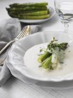 Asparagus soup with herbs, focus on foreground — Stock Photo
