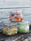 Traditional swedish pickled herrings in jars, focus on foreground — Stock Photo