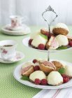 Raspberry cakes on cake stand, focus on foreground — Stock Photo