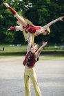 Two circus acrobats performing in park — Stock Photo