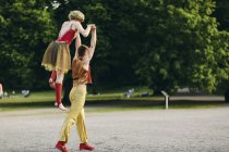 Female and male acrobats performing in park — Stock Photo