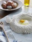 Flour and egg for pasta dough, differential focus — Stock Photo
