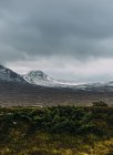 Landscape with snowcapped mountains and overcast sky — Stock Photo
