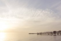 Seascape with jetty at sunset, tranquil scene — Stock Photo