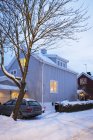 Auto parcheggiata da casa illuminata in inverno — Foto stock