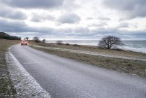 Car on road by sea, northern europe — Stock Photo