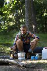 Hiker preparing food on camping stove — Stock Photo