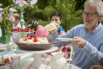 Family eating dessert outdoors, selective focus — Stock Photo