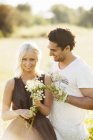 Couple at sunlit field, selective focus — Stock Photo