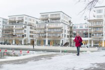 Man walking near building exteriors, focus on foreground — Stock Photo