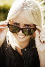 Woman with blonde hair smiling and looking at camera — Stock Photo