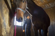 Woman with black hair in stables, selective focus — Stock Photo