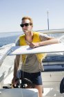 Young man driving speedboat, focus on foreground — Stock Photo