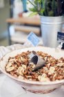 Bowl of nuts and dried bananas, focus on foreground — Stock Photo