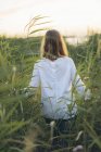 Молодая женщина, идущая по полю травы в Карлскруне, Швеция — стоковое фото