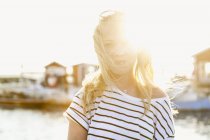 Teenage girl standing at harbor in Hano, Sweden, focus on foreground — Stock Photo