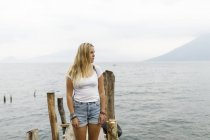 Woman standing on pier, focus on foreground — Stock Photo