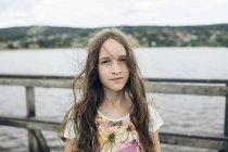 Portrait of girl by lake, focus on foreground — Stock Photo
