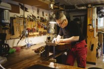 Artisanat travaillant dans un atelier de fabrication de guitare — Photo de stock
