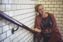 Mid adult woman standing in stairwell, selective focus — Stock Photo
