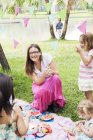 Madre con bambini al picnic di compleanno, concentrarsi sul primo piano — Foto stock