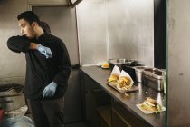 Шеф-кухар готує бургери в харчовій машині, вибірковий фокус — стокове фото