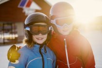 Portrait of boy and girl in safety helmets, focus on foreground — Stock Photo