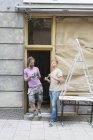 Friends talking during renovation, selective focus — Stock Photo