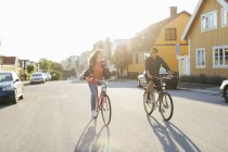 Couple cycling on suburban street — Stock Photo