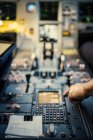 Pilot hand on airplane control panel, selective focus — Stock Photo