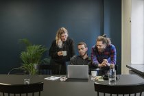 Coworkers looking at laptop, selective focus — Stock Photo