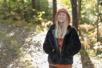 Smiling teenage girl with her eyes closed in forest — Stock Photo