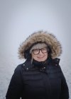 Portrait of senior woman in snow — Stock Photo