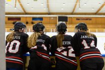 Girls in ice hockey uniforms beside ice rink — Stock Photo