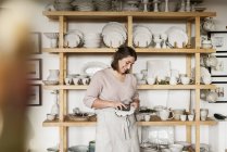 Woman cleaning pottery, selective focus — Stock Photo