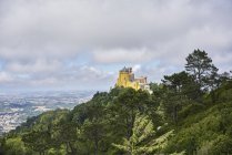 Pena Palace by trees in Sintra, Portugal — Stock Photo